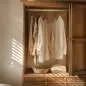Preview: Edelstahl-Holz-Kleiderstange, montiert in einem schönen Holzschrank