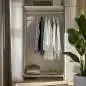 Preview: Edelstahl-Garderobenstange mit Wandflansch, montiert in einem stilvollen Kleiderschrank mit aufgehängter Kleidung