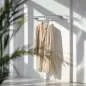 Preview: Maßgefertigte Edelstahl-U-förmige Garderobenstange von Steel-Deal, montiert in einem stilvollen Raum mit Kleidung, die daran hängt